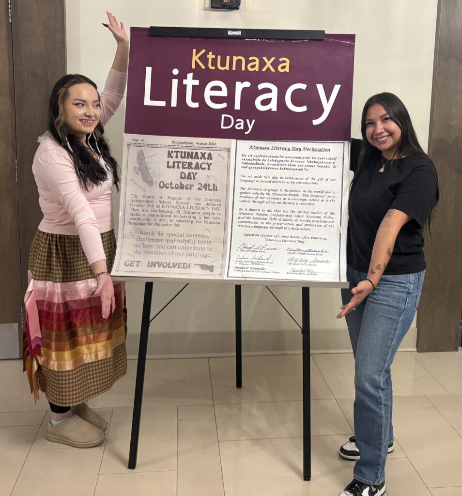 Alexis Johnson and Aiyana Twigg with sign declaring literacy day